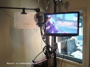 Inside the vo booth looking at the control room glass